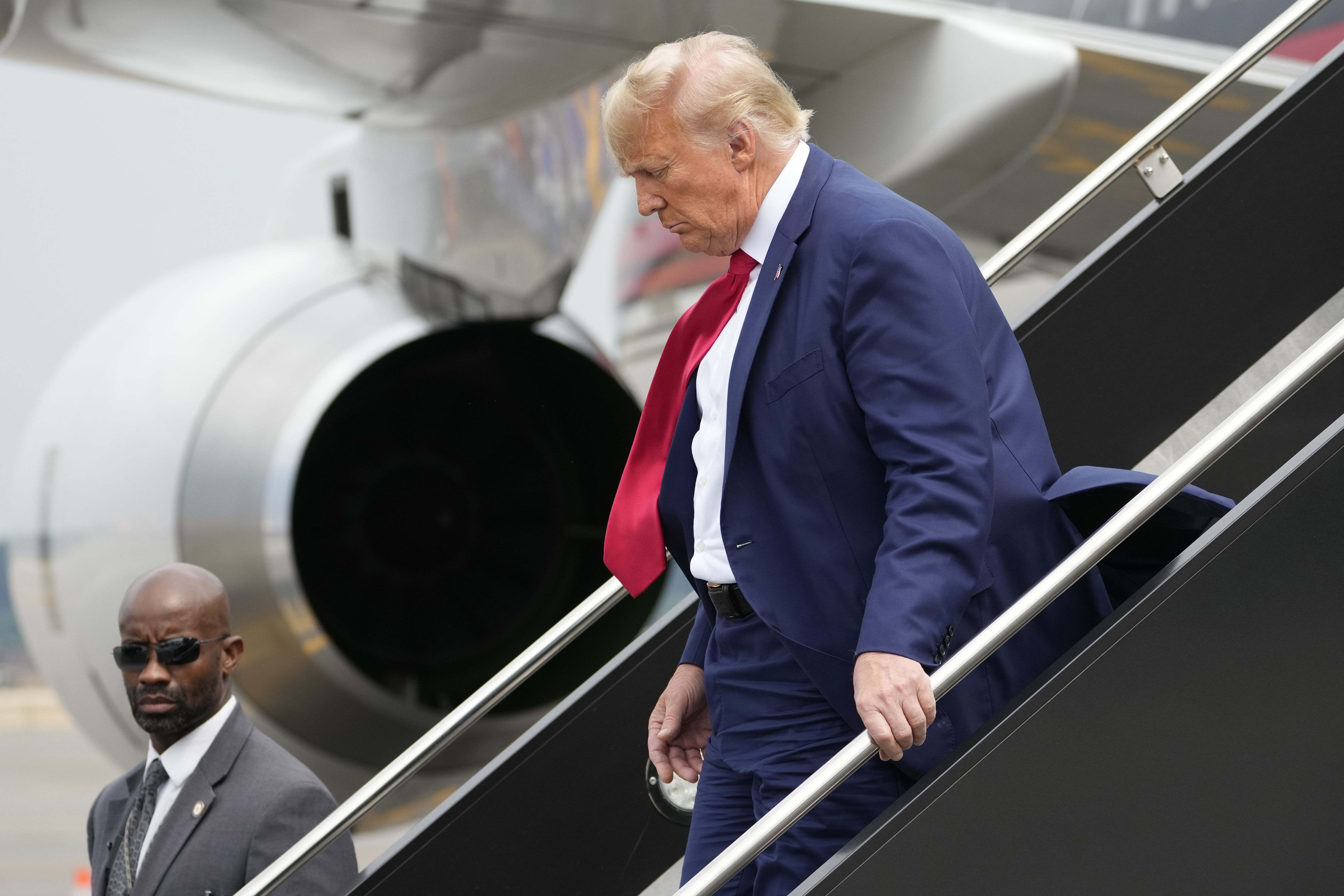 Trump heads to Iowa hoping to refocus attention from shootings to the economy