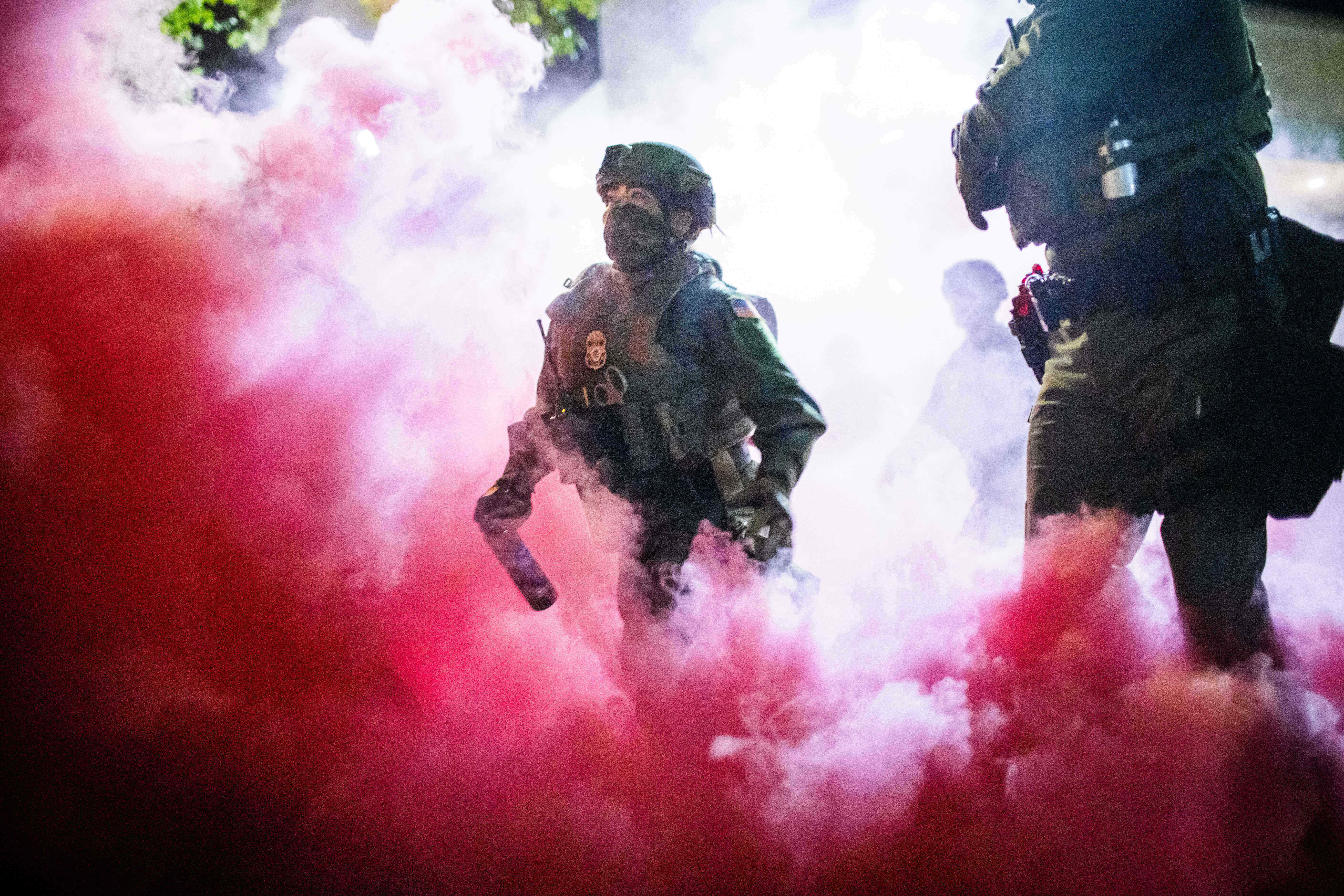 Law enforcement dispersing protesters near a U.S. Immigration and Customs Enforcement facility in Portland, Oregon.