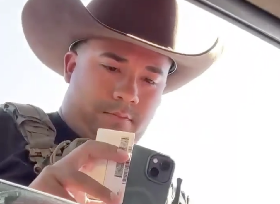 An ICE officer examines the driver's license of Dodge City, Kansas resident Guadalupe Navarrete on Sept. 23, 2026, during a wave of enforcement stops near local meatpacking plants.